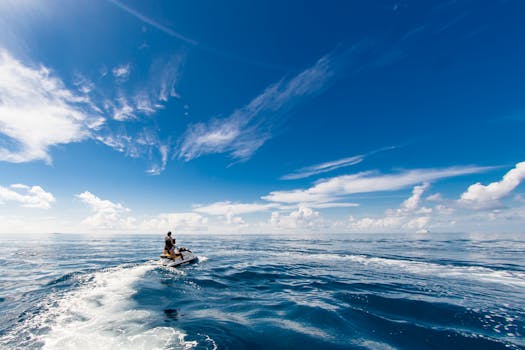 A thrilling jet ski ride on the open ocean beneath bright blue skies, perfect for adventure seekers.